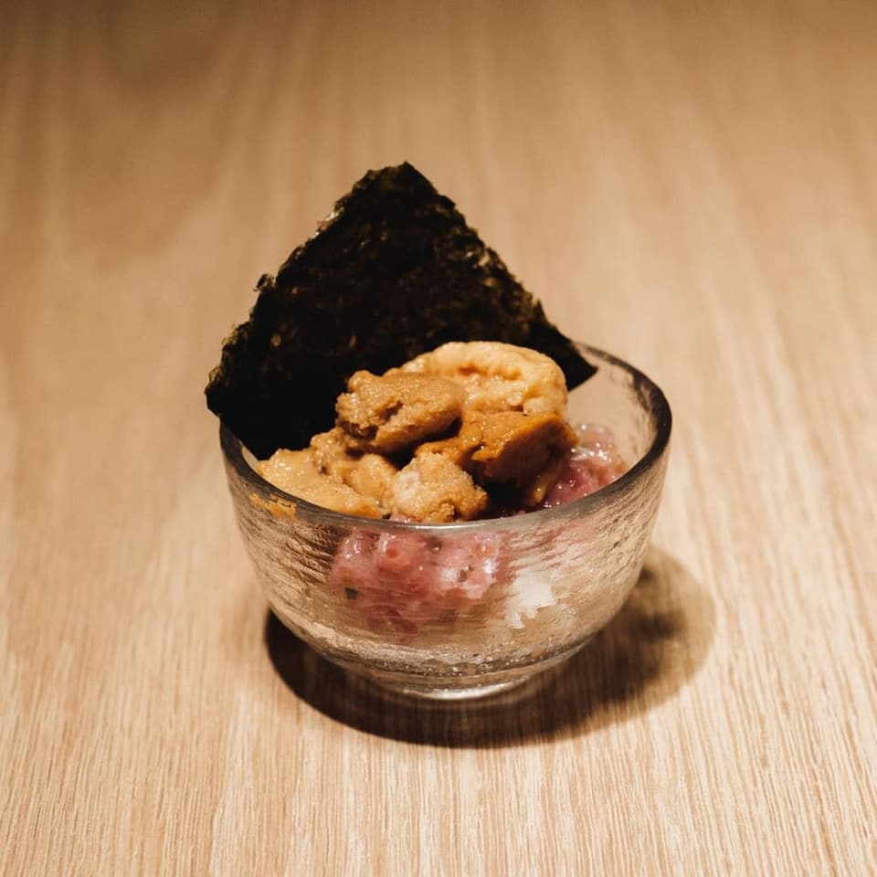 A small opening dish of sea urchin and tuna on toasted nori
