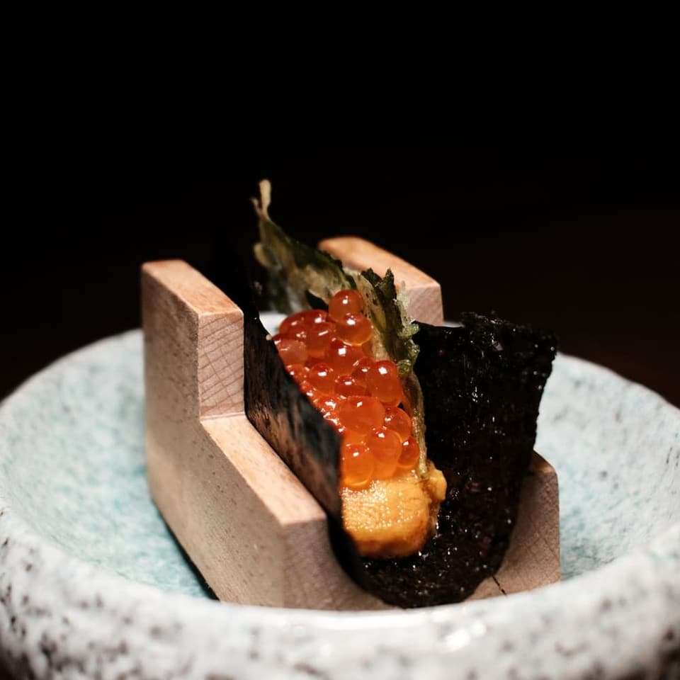 A piece of nigiri set down at the counter