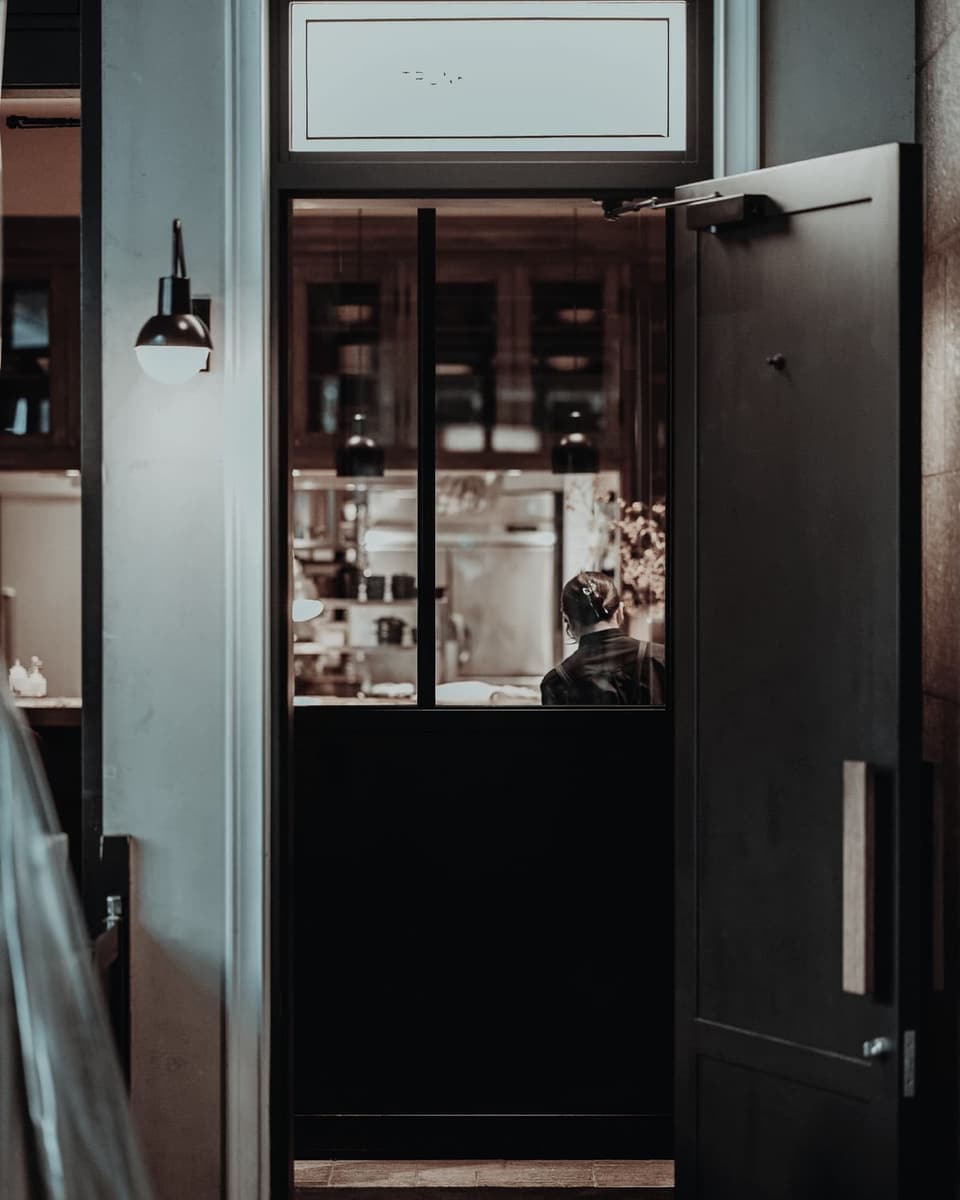 An open door with warm light behind it